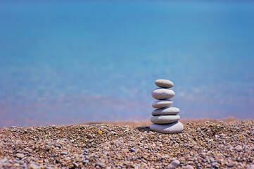 Fototapeta na wymiar Stack of pebble stones with sea on the background