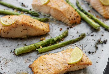 Baked Delicious salmon, green asparagus and lemon in pan