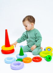 Children play with toys of room. Baby boy playing on the floor.