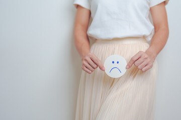 Woman hold Bad and unhappy Face paper over abdomen. Ovarian and Cervical cancer, Endometriosis,...