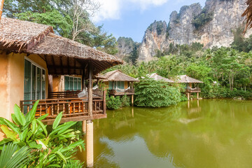 Fototapeta premium Beautiful lake resort nestled in nature with stunning mountain views. Tranquil scenery perfect for outdoor leisure and relaxation. Concept of travel and vacation.