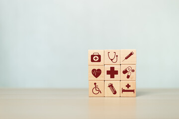 Wooden block with healthcare medical icons orange pastel background. stacking wooden cube box medical. healthcare treatment concept.