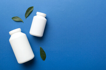 supplement pills with medicine bottle health care and medical top view. Vitamin tablets. Top view mockup bottle for pills and vitamins with green leaves, natural organic bio supplement, copy space - Powered by Adobe