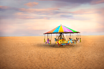 Carousel Merry go round horse at famous marina beach in Chennai, Asia s longest beach, colourful sky with merry-go-around horse moody for ads, Tamilnadu, Chennai, India