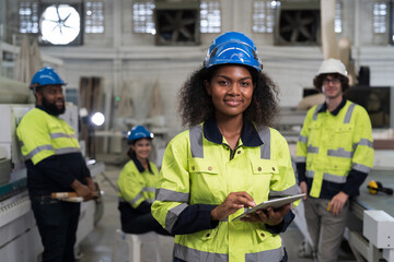 Portrait of happy smiling American African female engineer worker working in industry factory....
