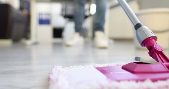 Cleaner washing floor in office with mop 4k movie. Cleaning service for apartments and offices concept