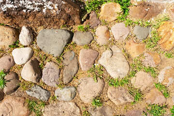 The road is paved with round, hewn stones