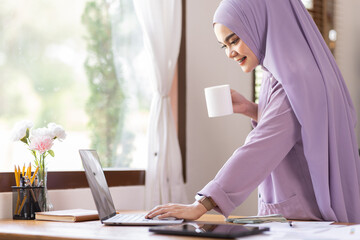 Fototapeta na wymiar Listen to coach. Happy muslim woman at home during online lesson. Modern technologies, remote education, ethnicity and tradition concept. Human emotions, lifestyle. Using tablet laptop sitting at home