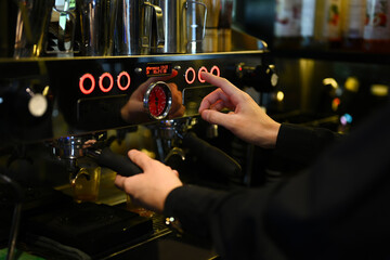 Cropped shot of barista preparing coffee for customer order in trendy coffee. Small business concept