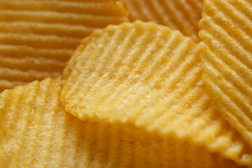 Gold wavy potato chips close up