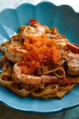 closeup spicy fried shrimp pasta on top with mentaiko