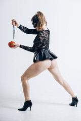 Fototapeta premium Two female buttocks in leather black lingerie on a white background