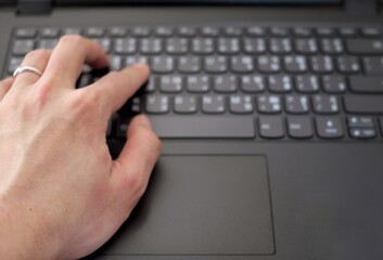 men's hand is typing on computer keyboard, vintage tone
