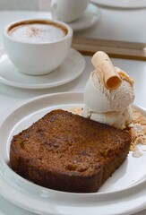 chocolate banana cake and vanilla ice cream with hot coffee background