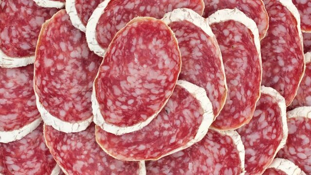 Sliced sausages salami in white mold