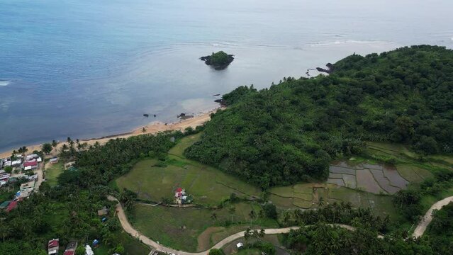Natural Scenic Of A Small Village And Lush Greenery Nearby The Sea At Baras, Catanduanes In The Philippines. aerial