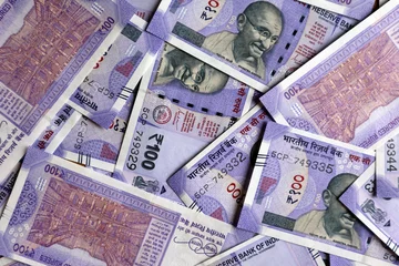 Fotobehang New Indian currency 100 rupees notes background  © stockclick
