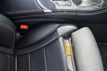 Forgotten gas lighter in car on seat can lead to fire in sunny hot weather. Rays of sun heating lighter on driver's seat. Random dangerous life situations. Carelessness in use of flammable objects.