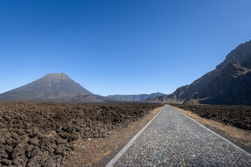 Pico do Fogo (2829m) rising from the caldera, old lava fields with new road