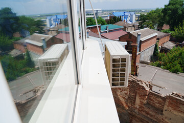 outdoor air conditioning unit on the wall of the house