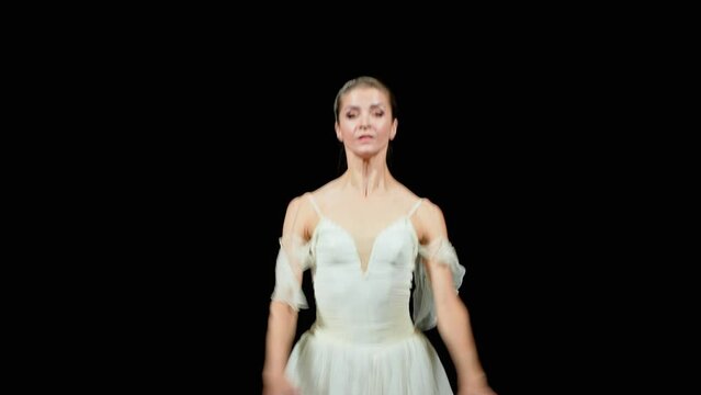 Ballet, graceful ballerina in a white tutu dance and perform choreographic elements on a black background, beautiful dramatic dance, 4k slow motion, 30fps.