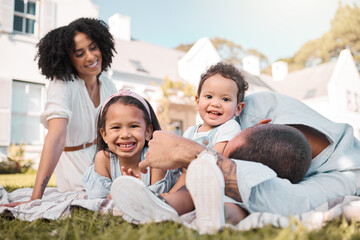 Love, blended family and parents on the lawn with their children in the garden of their home together. Mother, father and portrait of kids sitting on the grass in the yard of their house for bonding