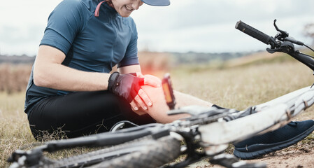 Injury, accident and a man with knee pain and a bike in nature after cycling or travel for fitness. Sports, cardio inflammation and a biker with a medical emergency on a bicycle in the countryside - obrazy, fototapety, plakaty