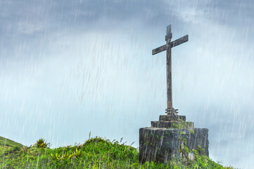 Christian cross in the rain in nature