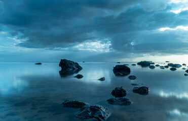 calm sea and rocks in overcast weather