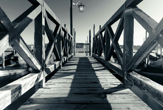 Wooden pontoon black and white on lagoon