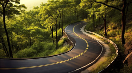 Winding curvy rural road with light trail from headlights leading through countryside.