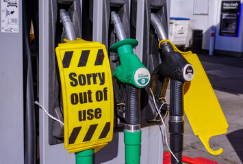 petrol pumps with out of use tag on hose. service gas station out of fuel. 