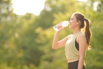 Beautiful Asian woman drinking water from the bottle water after concept healthy lifestyle and sport.