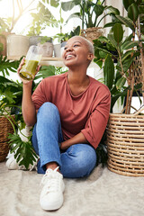 Healthy, black woman and green juice for nutrition or wellness with smile for diet in home with...