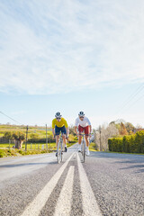 Fototapeta premium Fitness, mockup or people cycling on bicycle for training, cardio workout or race exercise in countryside. Space, male friends or sports athletes riding bike on road or path for a challenge together