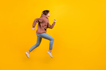 Fototapeta na wymiar Full body side photo of running hurry fast speed woman wear sport casual outfit empty space destination isolated on yellow background