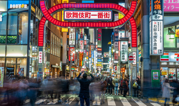 Tokyo - March 15, 2019 : Panoramic view of Unidentified person making pictures and Motion blured people walking at Kabukicho entertainment and Red Light district in Shinjuku Ward, Tokyo
