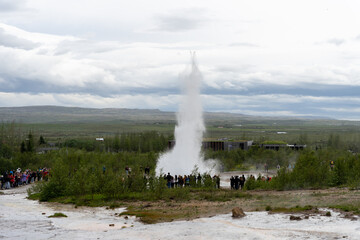 Iceland - 06.30.2023: Tourists watching Strokkur geyser erupting