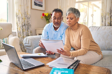 Laptop, documents and finance with a senior couple in the home living room for retirement or budget planning. Computer, accounting or investment savings with a mature man and woman in a house