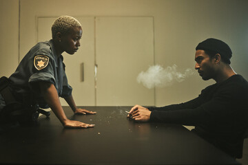 Man, smoking and detective talking in interrogation room with criminal, suspect or interview with a gangster. Police officer, questioning and statement of truth on crime and person with cigarette - obrazy, fototapety, plakaty