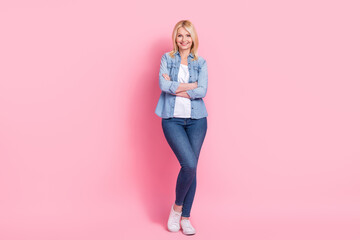 Full body photo of confident smiling expert sales manager senior woman boss develop strategies for company isolated on pink background