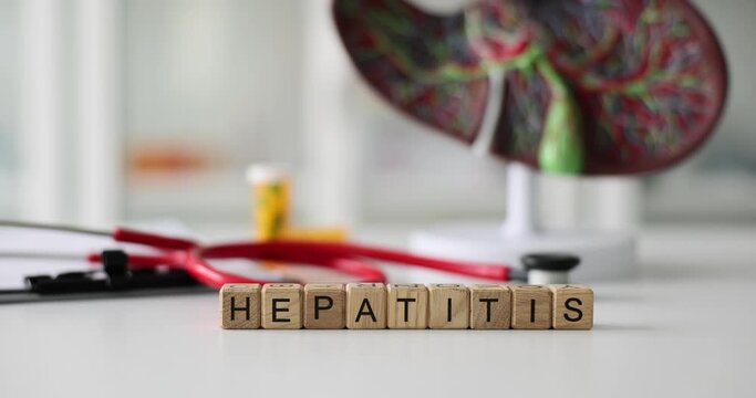 Word hepatitis stethoscope and liver anatomy in clinic. Hepatitis healthcare and treatment concept