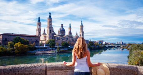 Woman looking at Basilica of Our Lady of Pillar in Spain, Europe.