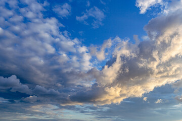 White clouds on a summer blue sky in cartoon style for background or wallpaper design. The whiteness of round clouds in a blue sky. High clouds in the sky.
