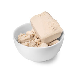 Pieces of compressed yeast in bowl isolated on white