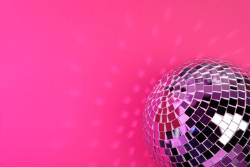 Shiny disco ball on pink background. Space for text