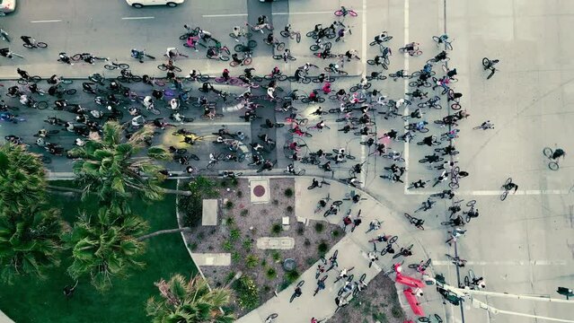 Bicycles take over a street and move out blasting music
