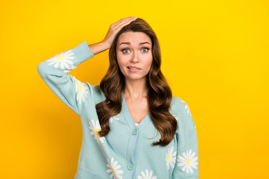 Photo of young funny clueless nervous lady wear turquoise cardigan hand head problems hesitate forgot wallet isolated on yellow color background