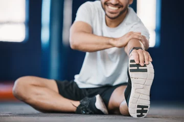 Deurstickers Fitness Foot, exercise and stretching with a sports man in the gym getting ready for a cardio training routine. Fitness, health and warm up with a male athlete in preparation of a workout for wellness