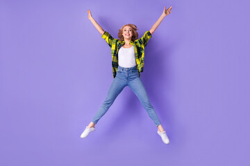 Fototapeta na wymiar Full body photo of woman wear checkered jacket jump star active vacation relax positive shopping ad isolated on purple color background